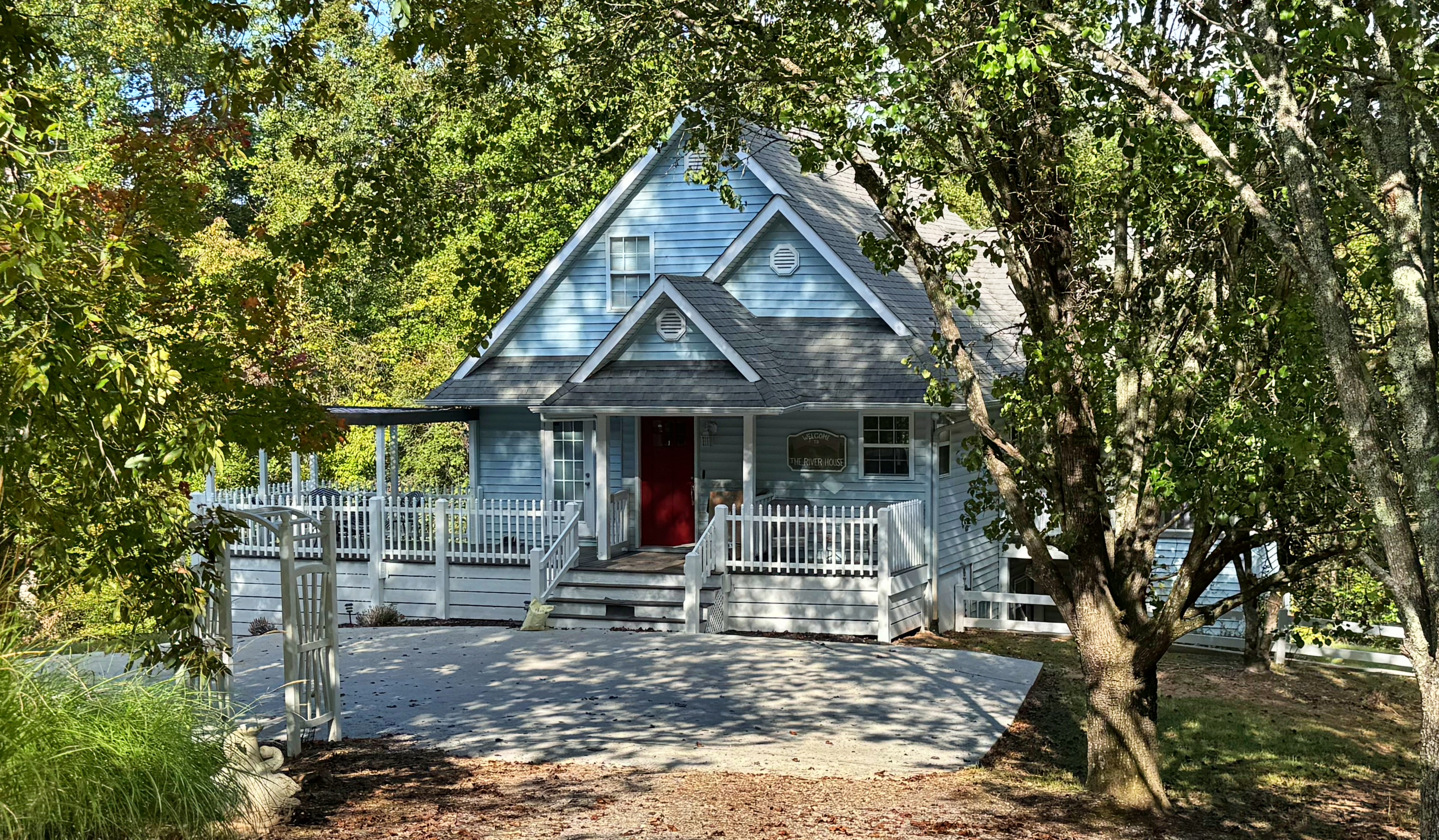 Light blue cottage home nestled in the trees