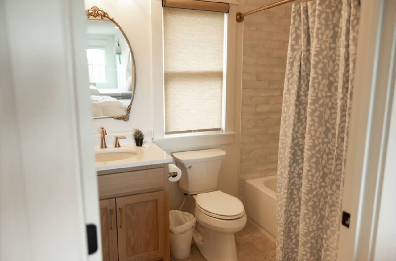 Bathroom with tub shower combination and neutral decor