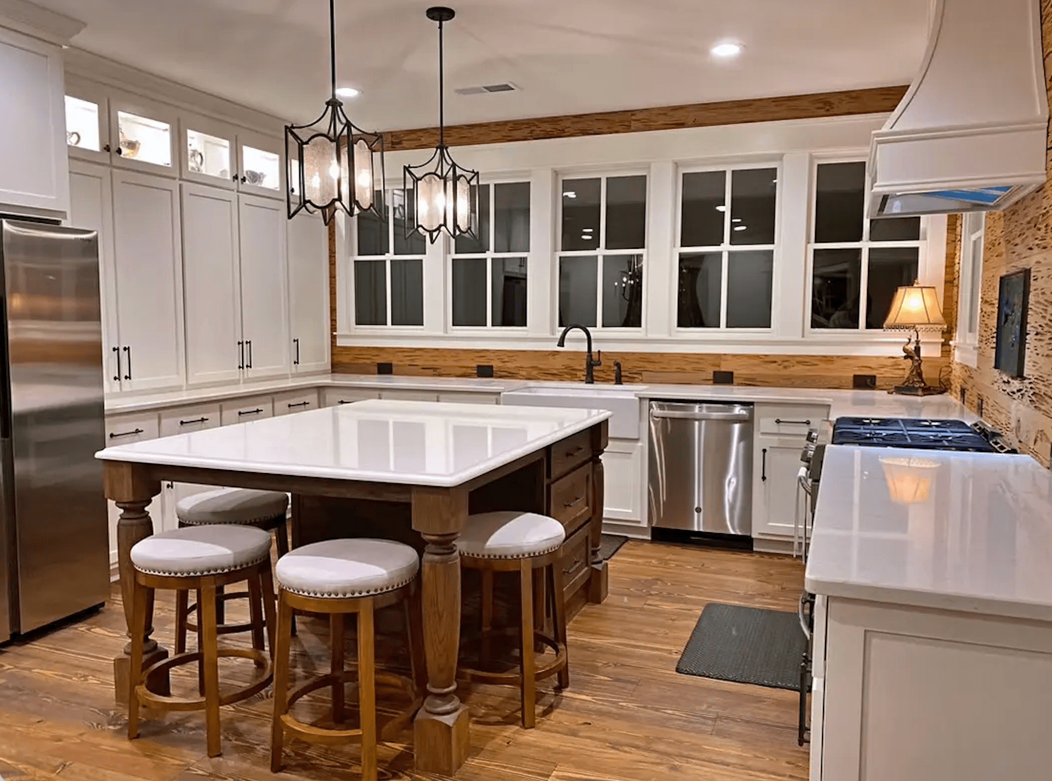 Modern kitchen with white cabinetry, a central island, and wooden accents.