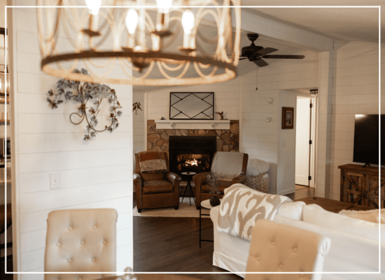 Cozy living room with a fireplace, comfortable seating, and warm decor.